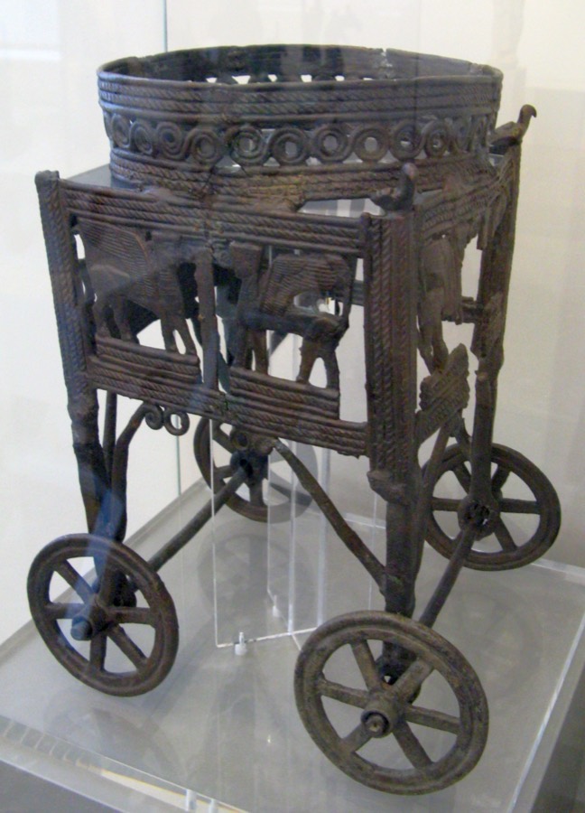 A small bronze four-wheeled cult-stand from Cyprus, c. 1050–950 BC: an openwork square base on chariot-like wheels — the closest known parallel to Solomon's laver-stands.