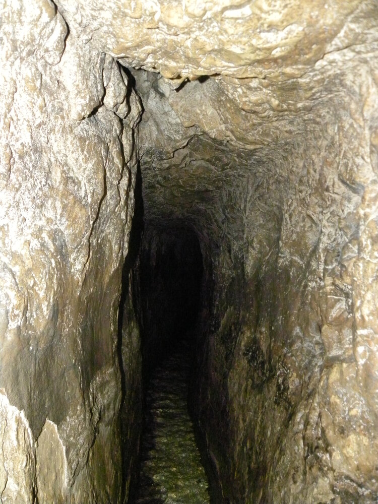 Inside Hezekiah's Tunnel — the narrow rock-cut water channel winding through bedrock beneath the City of David